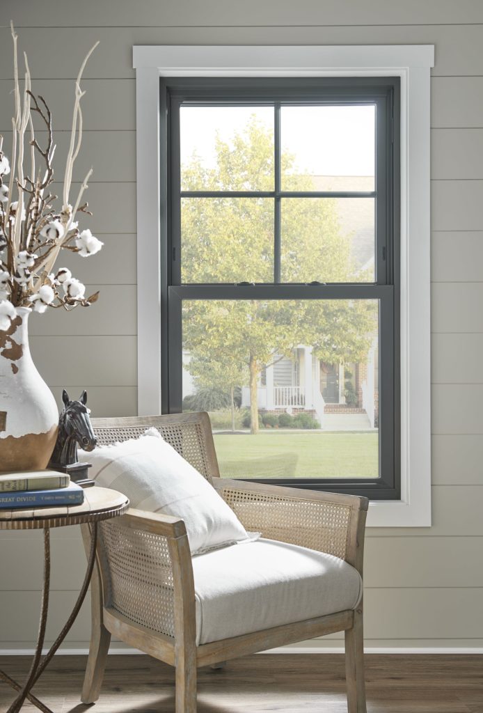 Black, double hung window behind chair